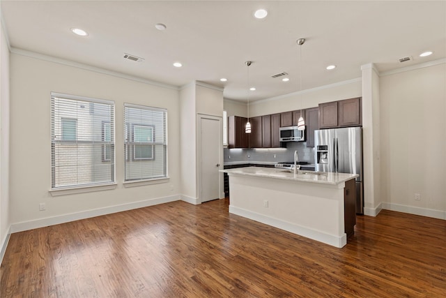 5909 Ross Ave Unit 2, Dallas, TX 75206 - kitchen featuring stainless steel appliances, dark brown cabinets, crown molding, an island with sink, and backsplash