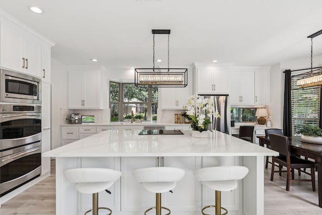 1117 Charleston Ct, Keller, TX 76248 - kitchen featuring appliances with stainless steel finishes, a chandelier, white cabinetry, light wood finished floors, and recessed lighting