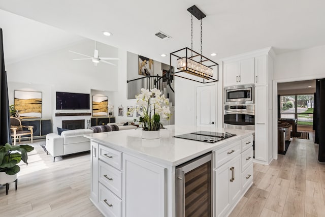 1117 Charleston Ct, Keller, TX 76248 - kitchen with wine cooler, stainless steel appliances, light wood finished floors, white cabinets, and recessed lighting