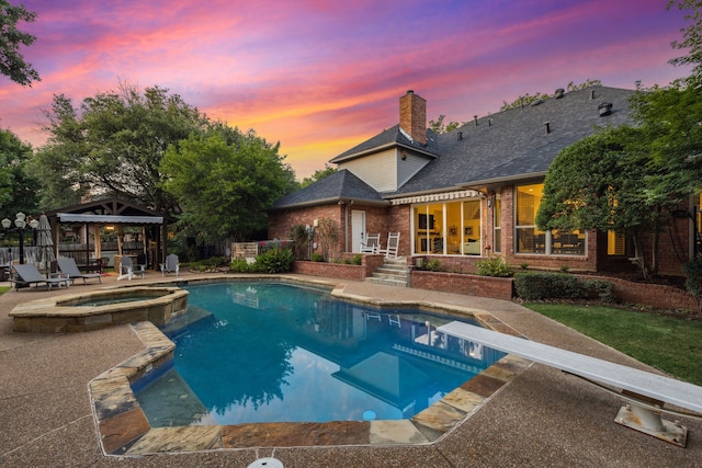 1117 Charleston Ct, Keller, TX 76248 - pool at dusk featuring a gazebo, a patio area, a pool with connected hot tub, and a diving board