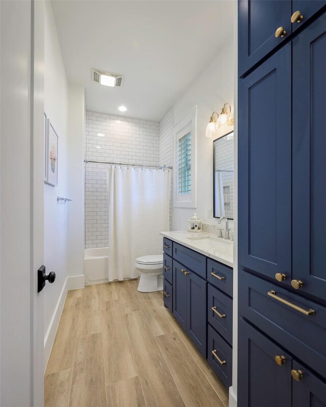 36 Mirror Lakes Ct, Gunter, TX 75058 - bathroom with vanity, toilet, wood finished floors, and shower / tub combo with curtain