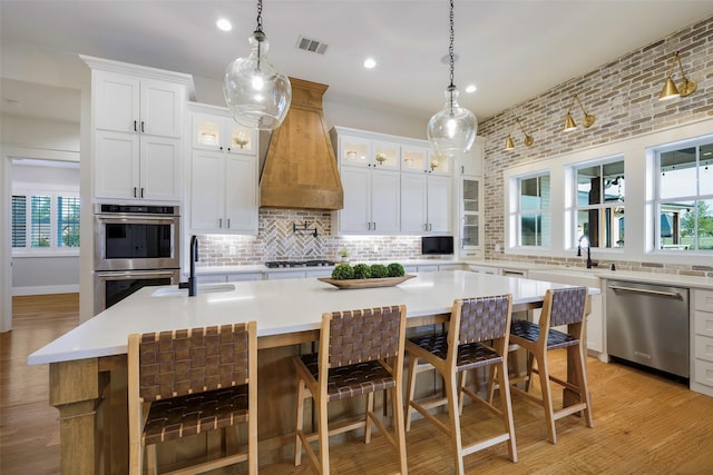 36 Mirror Lakes Ct, Gunter, TX 75058 - kitchen with stainless steel appliances, a sink, tasteful backsplash, a center island with sink, and recessed lighting