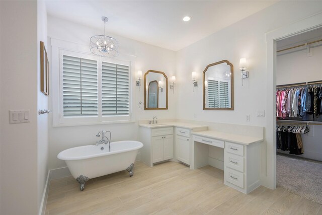 36 Mirror Lakes Ct, Gunter, TX 75058 - full bath with wood finished floors, a freestanding tub, vanity, a chandelier, and a spacious closet