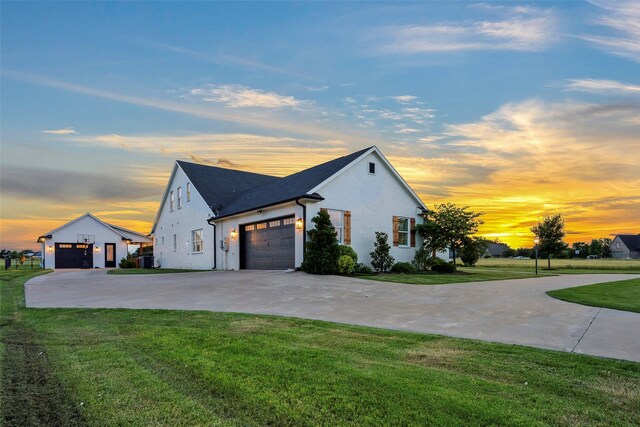 36 Mirror Lakes Ct, Gunter, TX 75058 - property exterior at dusk with concrete driveway, a lawn, stucco siding, a garage, and a shingled roof