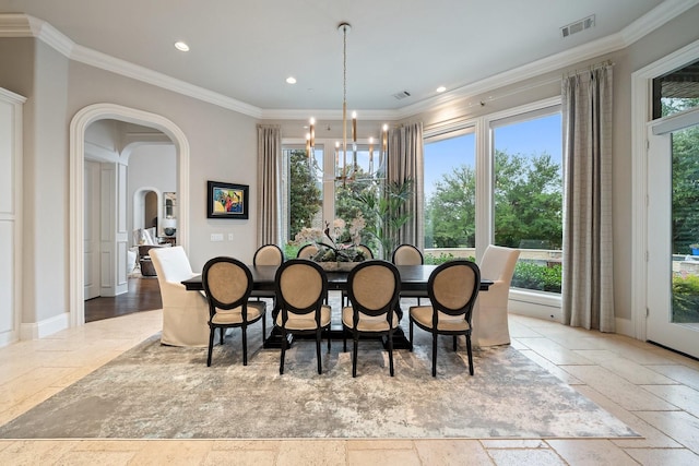 504 Bristol Dr, Allen, TX 75013 - dining area with stone tile flooring, a chandelier, crown molding, recessed lighting, and arched walkways