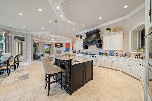504 Bristol Dr, Allen, TX 75013 - kitchen featuring custom range hood, crown molding, white cabinets, stone tile flooring, and tasteful backsplash