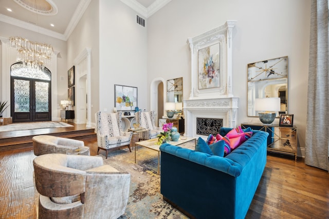 504 Bristol Dr, Allen, TX 75013 - living area with a high ceiling, french doors, hardwood / wood-style floors, a chandelier, and arched walkways