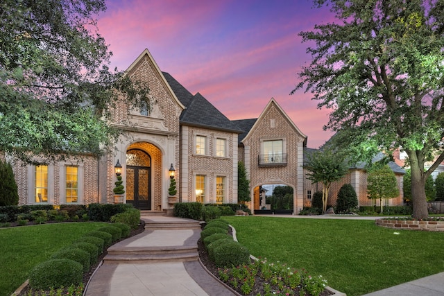 504 Bristol Dr, Allen, TX 75013 - french country style house featuring brick siding, a lawn, and french doors