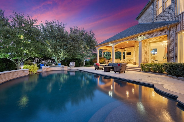504 Bristol Dr, Allen, TX 75013 - pool at dusk featuring a patio, outdoor lounge area, and a pool with connected hot tub