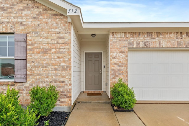 512 Leeward Ln, Crowley, TX 76036 - view of exterior entry featuring brick siding and a garage