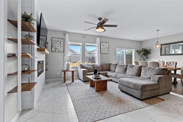 512 Leeward Ln, Crowley, TX 76036 - living area featuring light marble finish flooring, ceiling fan, a glass covered fireplace, and baseboards