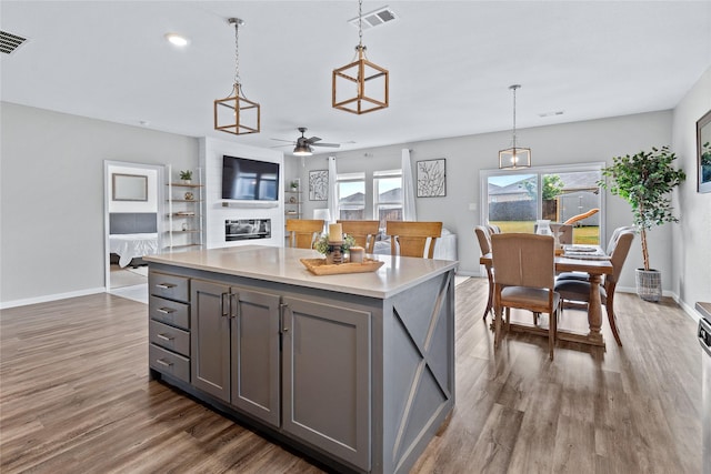 512 Leeward Ln, Crowley, TX 76036 - kitchen featuring gray cabinets, dark wood-type flooring, ceiling fan, baseboards, and decorative light fixtures