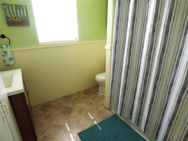 225 County Road 472, Ranger, TX 76470 - bathroom featuring wainscoting, toilet, and vanity