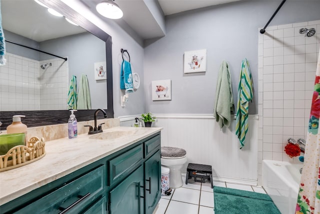 1434 Southland St, Sulphur Springs, TX 75482 - bathroom featuring tile patterned floors, vanity, toilet, shower / bathtub combination with curtain, and a wainscoted wall