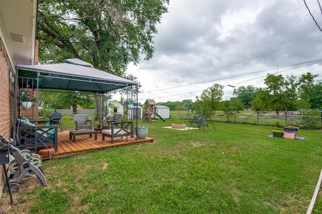 1434 Southland St, Sulphur Springs, TX 75482 - view of yard featuring a playground, a gazebo, a wooden deck, and a fire pit