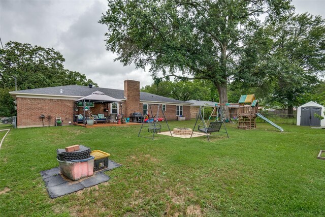1434 Southland St, Sulphur Springs, TX 75482 - view of yard with an outdoor fire pit, a playground, and a patio
