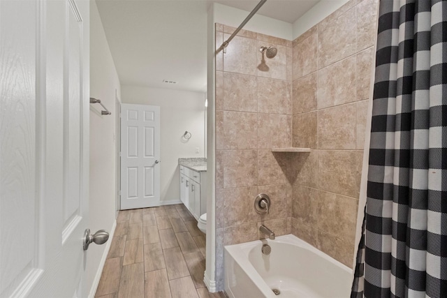 620 Ruthye Ln, Pilot Point, TX 76258 - bathroom featuring shower / bath combo with shower curtain, vanity, wood finish floors, toilet, and baseboards