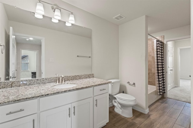 620 Ruthye Ln, Pilot Point, TX 76258 - bathroom featuring vanity, toilet, wood tiled floors, and shower / tub combo with curtain