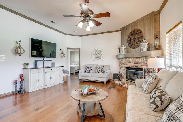 3809 Timbercrest Dr W, Burleson, TX 76028 - living room with ceiling fan, ornamental molding, light wood-style floors, a brick fireplace, and baseboards
