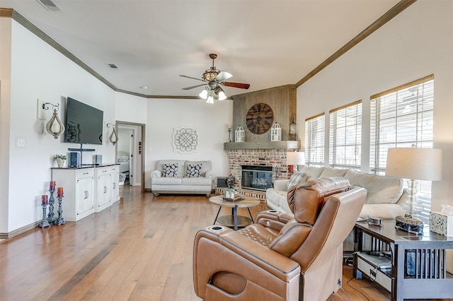 3809 Timbercrest Dr W, Burleson, TX 76028 - living area featuring ceiling fan, crown molding, light wood-style floors, a fireplace, and baseboards