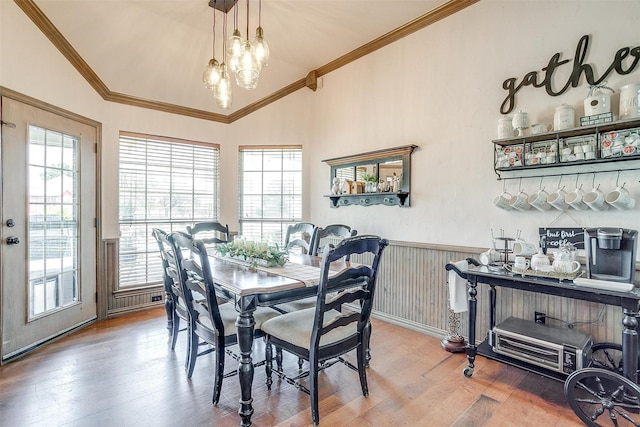 3809 Timbercrest Dr W, Burleson, TX 76028 - dining space featuring crown molding, wood finished floors, a chandelier, lofted ceiling, and wainscoting