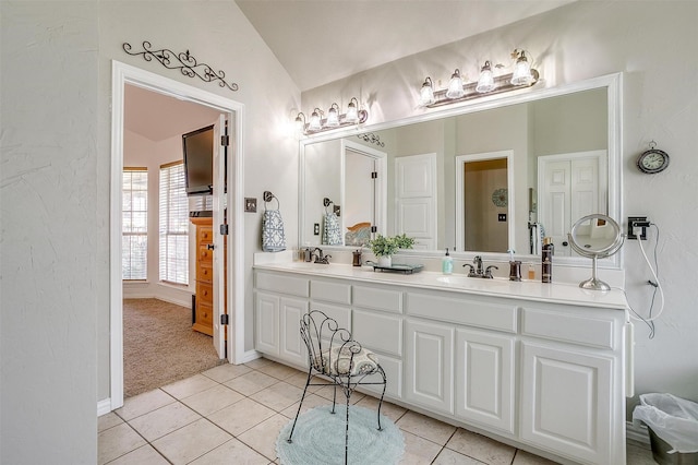 3809 Timbercrest Dr W, Burleson, TX 76028 - full bathroom with double vanity, vaulted ceiling, tile patterned flooring, and baseboards
