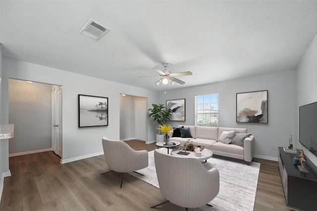 4811 Pachuca Ct, Dallas, TX 75236 - living room featuring wood finished floors, a ceiling fan, and baseboards