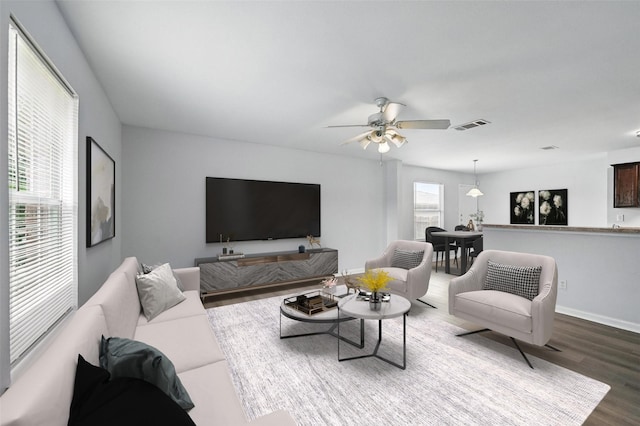 4811 Pachuca Ct, Dallas, TX 75236 - living area with dark wood-type flooring, a ceiling fan, and baseboards