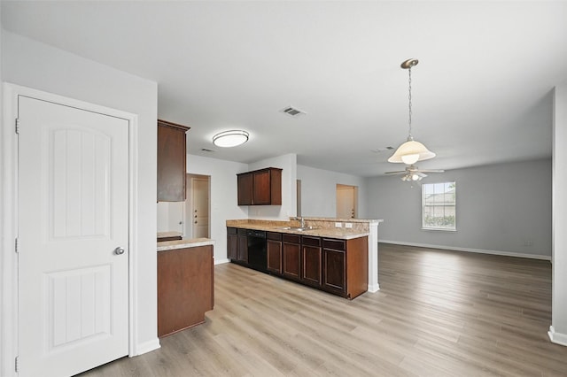 4811 Pachuca Ct, Dallas, TX 75236 - kitchen featuring dishwasher, baseboards, a peninsula, a sink, and light wood-style flooring
