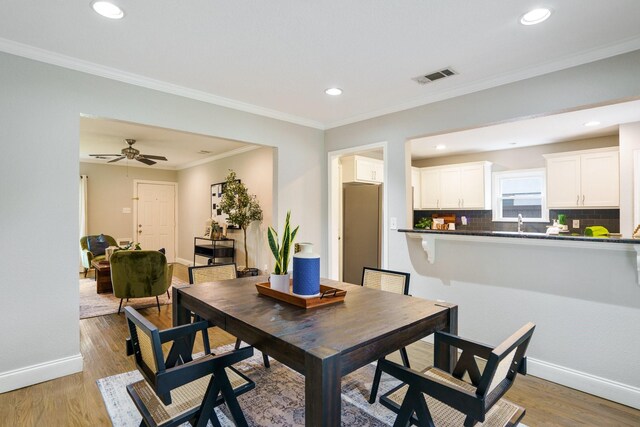 4731 Wateka Dr, Dallas, TX 75209 - dining room featuring baseboards, recessed lighting, light wood-style floors, and ornamental molding