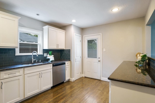4731 Wateka Dr, Dallas, TX 75209 - kitchen with dishwasher, a sink, backsplash, wood finished floors, and white cabinets