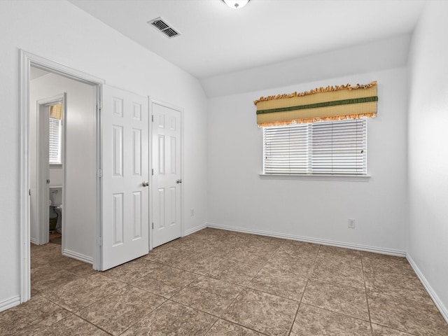 6915 Westside Pl, Sachse, TX 75048 - unfurnished bedroom featuring multiple windows, baseboards, a closet, and lofted ceiling