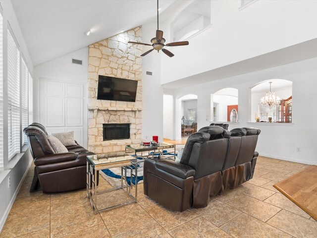6915 Westside Pl, Sachse, TX 75048 - living room with a ceiling fan, high vaulted ceiling, a fireplace, baseboards, and a chandelier