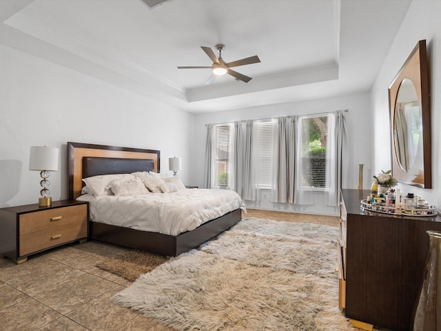 6915 Westside Pl, Sachse, TX 75048 - bedroom featuring a tray ceiling, tile patterned floors, and ceiling fan