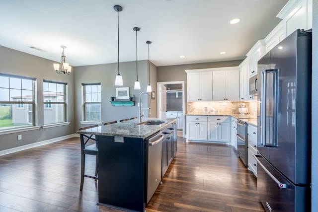 2503 Hollon Dr, Caddo Mills, TX 75135 - kitchen with appliances with stainless steel finishes, a sink, dark wood finished floors, a chandelier, and recessed lighting