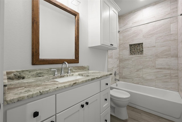 220 E 7th St, Weatherford, TX 76086 - full bathroom with vanity, toilet,  shower combination, and wood finished floors