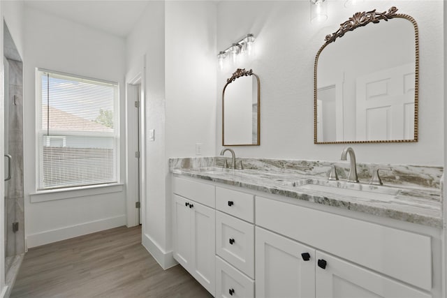 220 E 7th St, Weatherford, TX 76086 - full bath with double vanity, wood finished floors, baseboards, and a stall shower