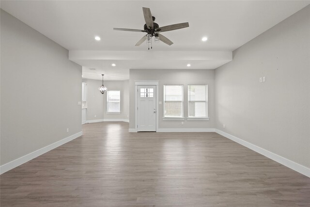 220 E 7th St, Weatherford, TX 76086 - unfurnished living room featuring baseboards, recessed lighting, wood finished floors, a ceiling fan, and a chandelier