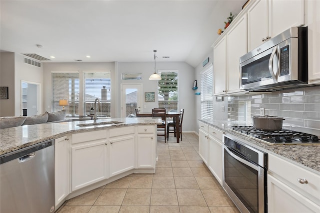 2800 Cedar Ridge Ln, Fort Worth, TX 76177 - kitchen featuring stainless steel appliances, a sink, light tile patterned floors, white cabinetry, and recessed lighting