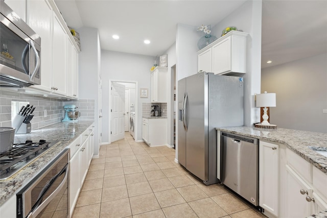 2800 Cedar Ridge Ln, Fort Worth, TX 76177 - kitchen with stainless steel appliances, tasteful backsplash, white cabinetry, light tile patterned floors, and recessed lighting
