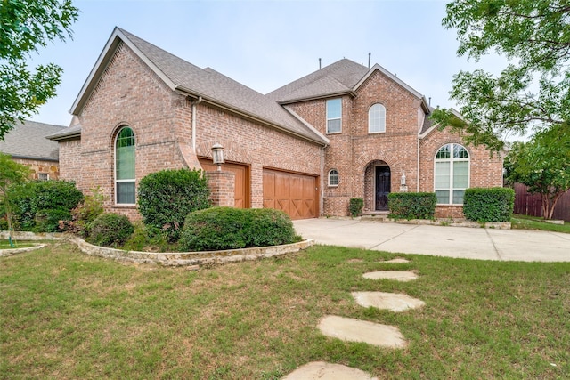 14669 Foxbriar Ln, Frisco, TX 75035 - traditional home featuring brick siding, concrete driveway, a garage, and a shingled roof