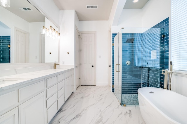 14669 Foxbriar Ln, Frisco, TX 75035 - bathroom with a stall shower, a freestanding tub, double vanity, and marble finish floors