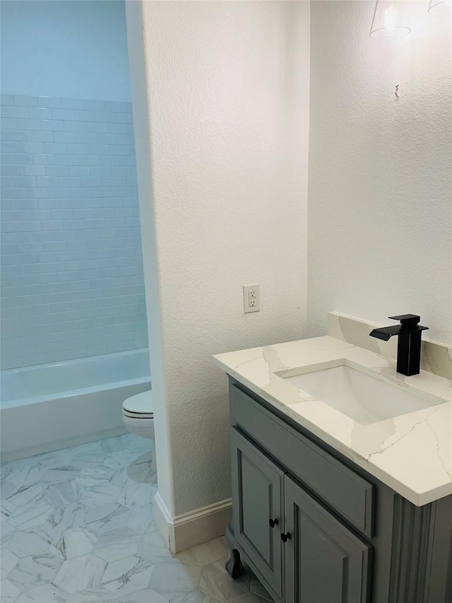 14669 Foxbriar Ln, Frisco, TX 75035 - bathroom featuring vanity, baseboards, marble finish flooring, toilet, and bathtub / shower combination