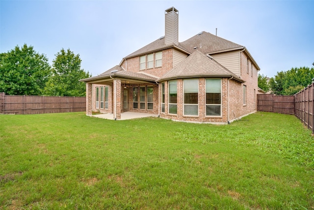 14669 Foxbriar Ln, Frisco, TX 75035 - back of property with a chimney, a patio, brick siding, and roof with shingles