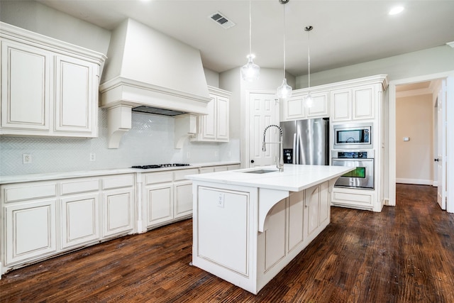 14669 Foxbriar Ln, Frisco, TX 75035 - kitchen with appliances with stainless steel finishes, a sink, custom exhaust hood, tasteful backsplash, and light countertops