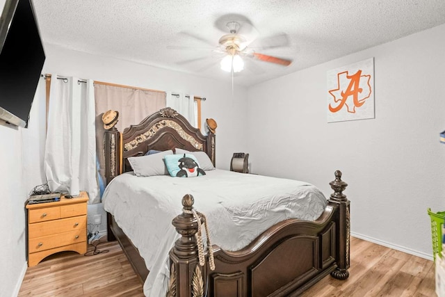 1011 Kleberg St, Alice, TX 78332 - bedroom with light wood-type flooring, a textured ceiling, ceiling fan, and baseboards