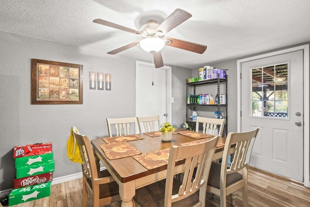 1011 Kleberg St, Alice, TX 78332 - dining space with a textured wall, wood finished floors, a textured ceiling, baseboards, and a ceiling fan