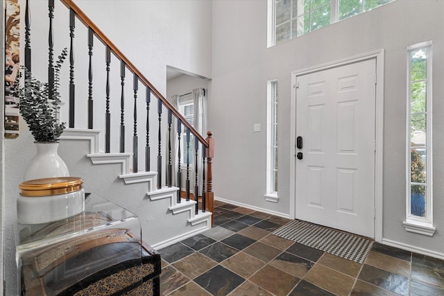 736 Fawn Valley Dr, Allen, TX 75002 - foyer featuring stone tile flooring, baseboards, stairs, and a towering ceiling