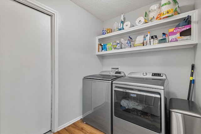 736 Fawn Valley Dr, Allen, TX 75002 - washroom featuring washing machine and clothes dryer, light wood finished floors, a textured ceiling, and baseboards