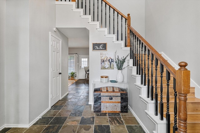 736 Fawn Valley Dr, Allen, TX 75002 - staircase featuring stone tile flooring, baseboards, and a high ceiling